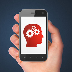 Image showing Advertising concept: Head With Gears on smartphone