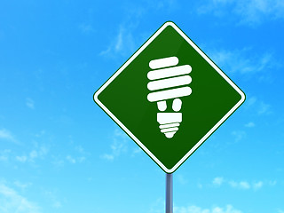 Image showing Finance concept: Energy Saving Lamp on road sign background