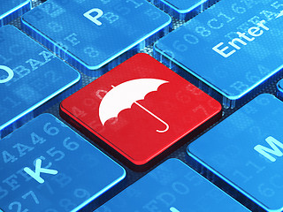 Image showing Protection concept: Umbrella on computer keyboard background