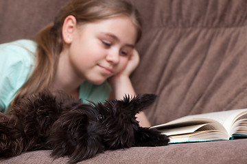 Image showing Dog and little girl on the sofa