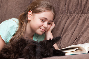 Image showing Little girl with a book and dog