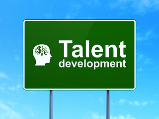 Image showing Education concept: Talent Development and Head With Finance Symbol on road sign background