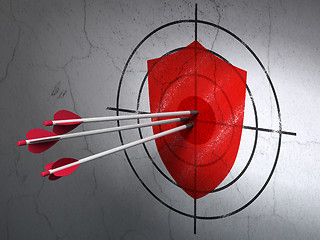Image showing Protection concept: arrows in Shield target on wall background