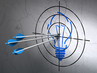 Image showing Business concept: arrows in Light Bulb target on wall background