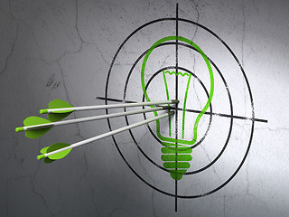 Image showing Business concept: arrows in Light Bulb target on wall background