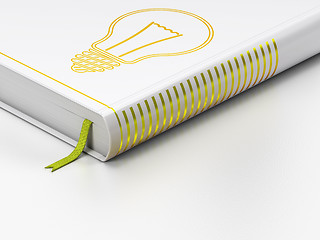 Image showing Finance concept: closed book, Light Bulb on white background