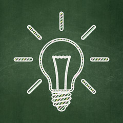 Image showing Finance concept: Light Bulb on chalkboard background