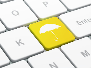 Image showing Protection concept: Umbrella on computer keyboard background