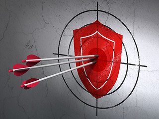 Image showing Protection concept: arrows in Shield target on wall background