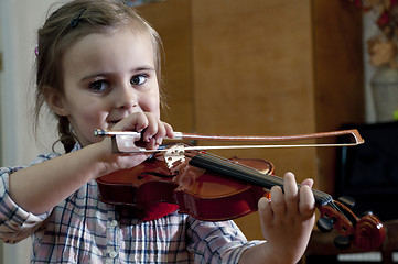 Image showing adorable little girl learning violin playing