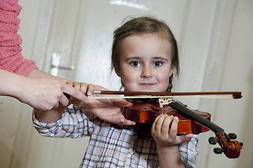 Image showing cute preschool girl learning violin playing