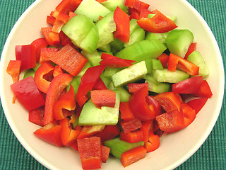 Image showing Slices of cucumber and red pepper in a ceramics bowl