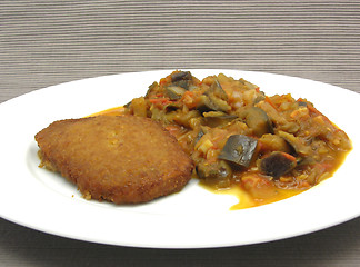 Image showing Breaded bean curd cutlet with fried vegetable on a white plate