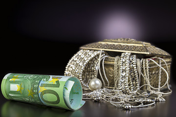 Image showing Silver jewelry and Euro 