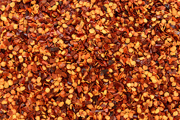 Image showing Dried chilli flakes and seeds abstract background texture