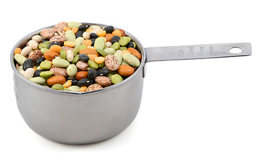 Image showing Mixed dried beans in a metal cup measure