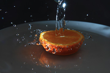 Image showing half of orange and fresh water