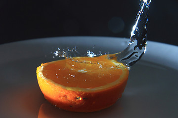 Image showing half of orange and fresh water