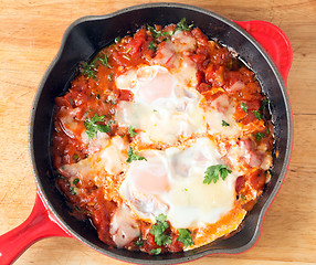 Image showing Eggs poached on tomato sauce from above