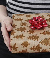 Image showing Young woman holding a present