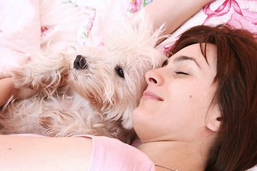 Image showing Dog sleeping on bed 
