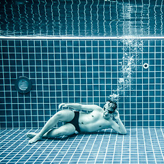 Image showing Persons lies under water in a swimming pool