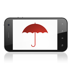 Image showing Protection concept: Umbrella on smartphone