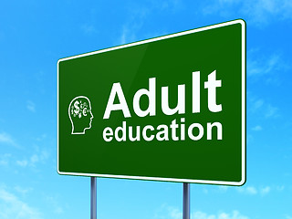 Image showing Education concept: Adult Education and Head With Finance Symbol on road sign background