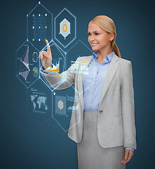 Image showing smiling businesswoman working with virtual screen