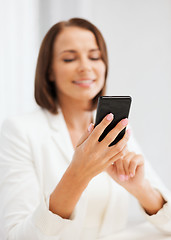 Image showing smiling businesswoman or student with smartphone