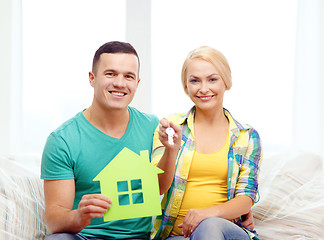 Image showing couple with green house and keys in new home