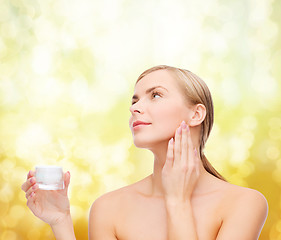 Image showing woman applying cream on her skin