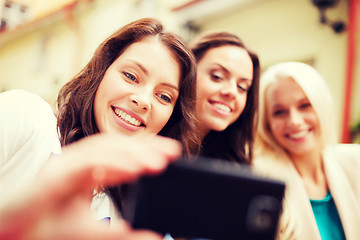 Image showing beautiful girls taking picture in cafe in city