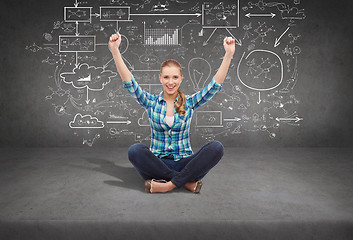 Image showing young woman in casual clothes sitting on floor