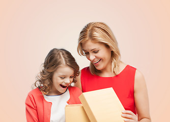 Image showing smiling mother and daughter with opening gisft box