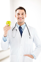 Image showing male doctor with green apple