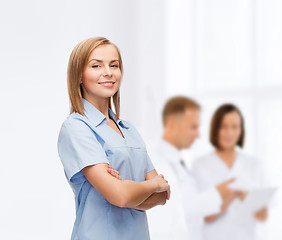 Image showing smiling female doctor or nurse