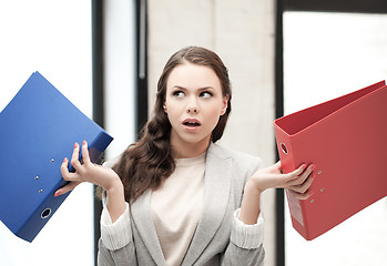 Image showing unsure thinking or wondering woman with folder