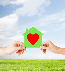 Image showing couple hands holding green paper house