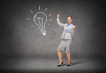 Image showing happy businesswoman with hands up