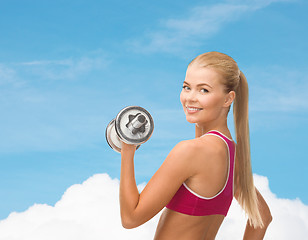 Image showing smiling woman with heavy steel dumbbell