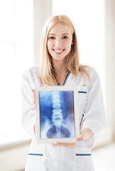 Image showing female doctor with x-ray on tablet pc