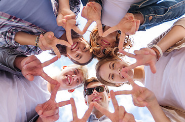 Image showing group of teenagers showing finger five