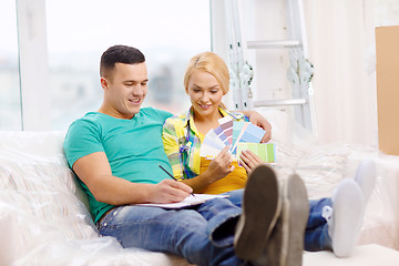 Image showing couple looking at color samples in new home