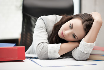 Image showing bored and tired woman behid the table