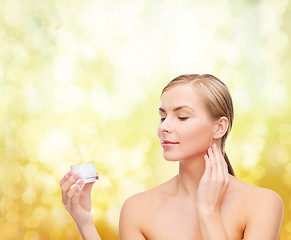 Image showing woman applying cream on her skin