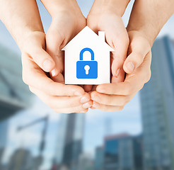 Image showing hands holding paper house with lock