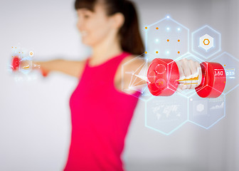 Image showing sporty woman hands with light red dumbbells