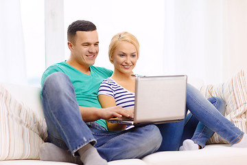 Image showing smiling happy couple with laptop at home