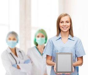 Image showing smiling female doctor or nurse with tablet pc